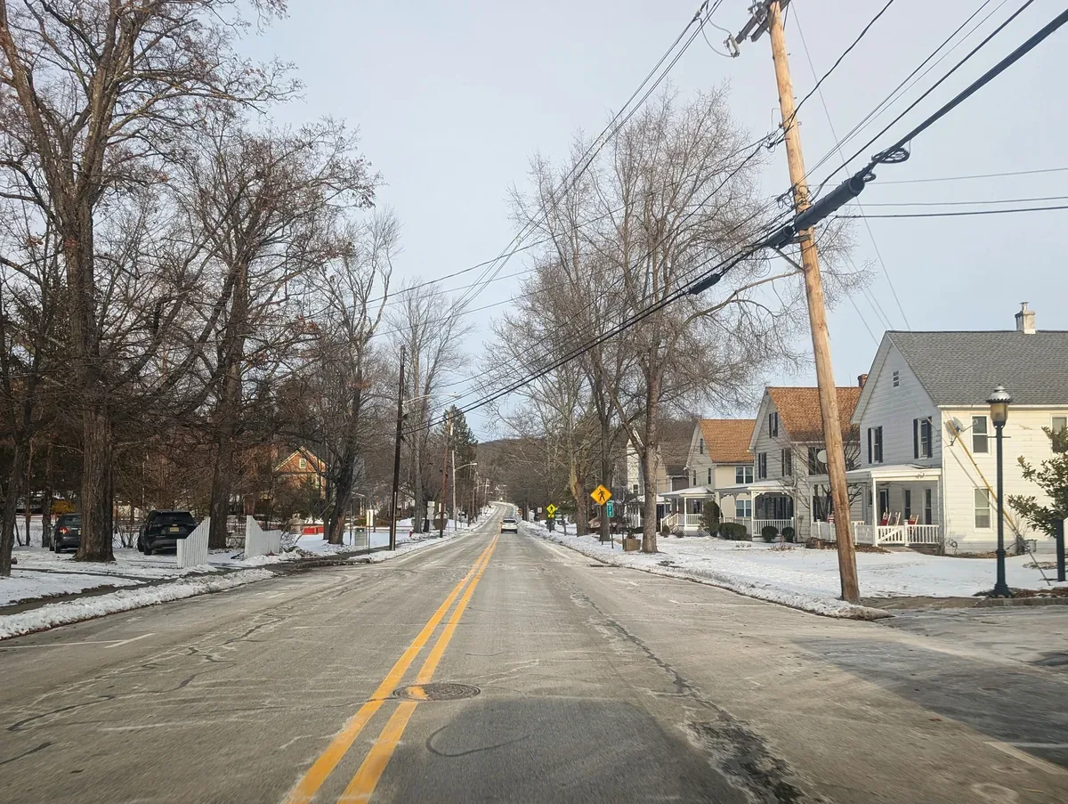 Tree-lined Wantage Avenue with older village houses in Branchville, New Jersey, in winter