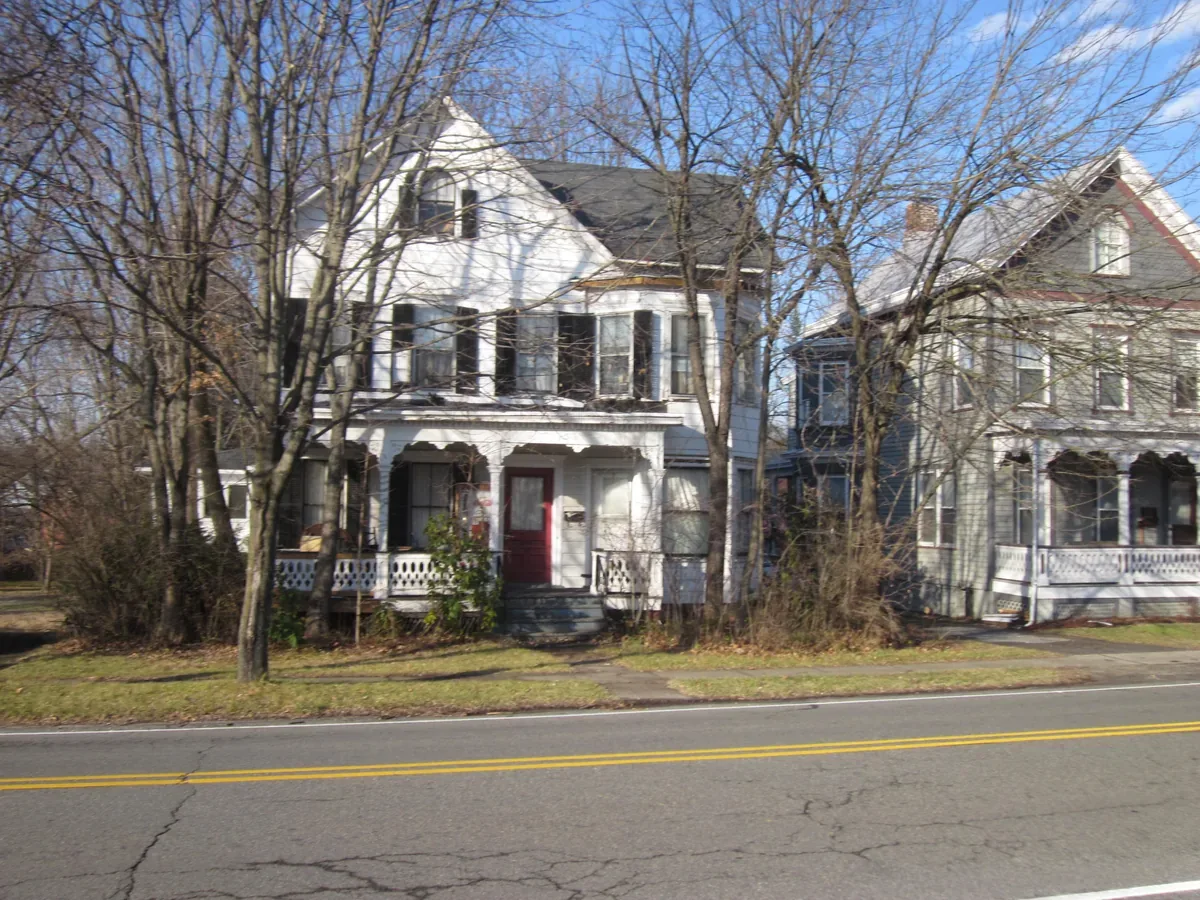 Victorian frame houses with porches on a residential street in Hamburg, New Jersey
